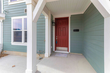 Townhouse porch with lockbox on the red front door