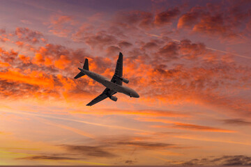 Aircraft flyingon a sunset background