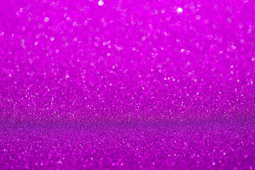 Violet glitter surface. Purple shimmer background in soft focus. Sparkling wrapping shiny paper....