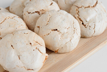 Meringue macro. Round chocolate meringue. Meringue on the dock. Meringue on a white background.