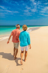Tropical island beach resort with seniors walking barefoot