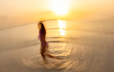 Fototapeta na wymiar Asian woman in tropical ocean with motion blur