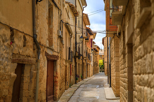 Rustic medieval stone houses in a narrow street of the old town of Olite, Spain famous for a magnificent Royal Palace castle