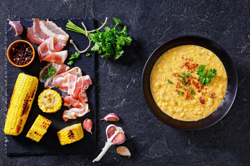 corn chowder in bowl on table, top view