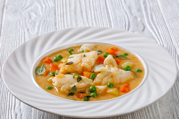 white fish chowder with green peas, potatoes