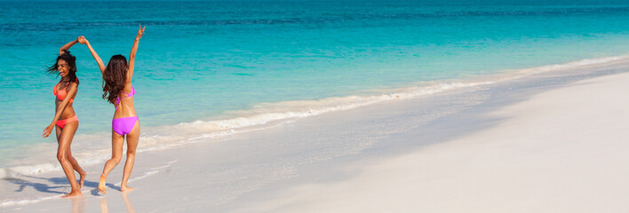 Panoramic girls having fun on tropical island vacation