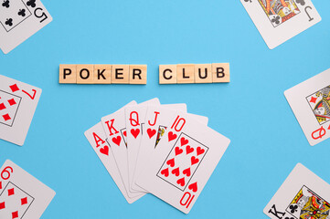 Poker Playing Cards on blue background with wooden blocks. Flatlay, copy space, concept