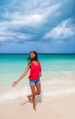 Beautiful young Afro American woman by tropical ocean