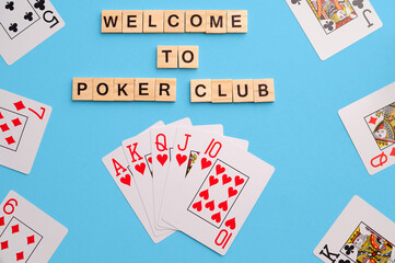 Poker Playing Cards on blue background with wooden blocks. Flatlay, copy space, concept