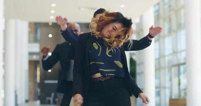 Carefree days in the office. 4k video footage of a group of carefree businesspeople dancing in their office.