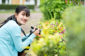 Woman is a professional photographer with  camera, outdoor and sunlight, Portrait, copy space.Beautiful woman taking picture outdoors