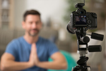 man filming his yoga workout