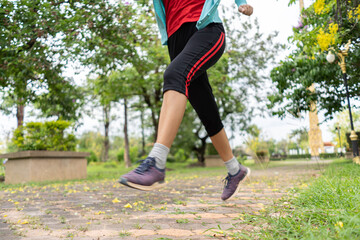 Fototapeta premium Fit young woman running in park.Running woman atletic spotsman trains in the summer park. Outdoor fitness portrait