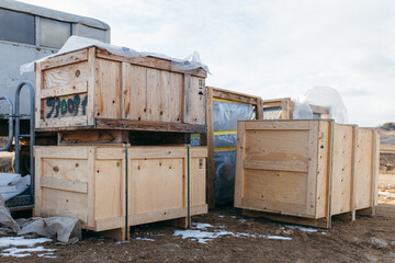 Wooden large boxes outdoor. Packaging of finished products of the plant. Boxes out of wood for packing industrial machinery. 