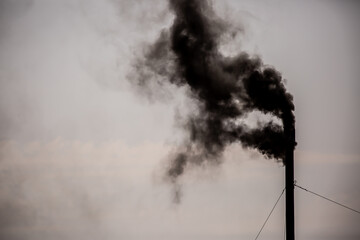 Working oil refinery. Smoke from the factory chimney. Ecological pollution. Air emissions polluting the city. Industrial waste is hazardous to health. Large factory in smog, Production in operation.