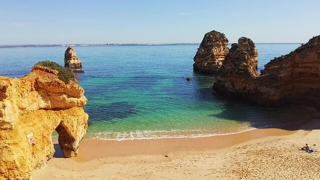 Praia da Boneca. Slowed down view over a tropical beach. Limestone archs inside the ocean. Rock formations and blue green transparent water. Empty beach, no people. Enjoying summertime. 