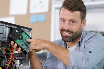 computer repair technician repairing hardware