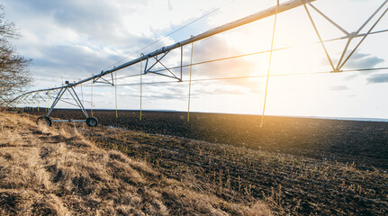 Empty field in winter with pivot sprinkler system