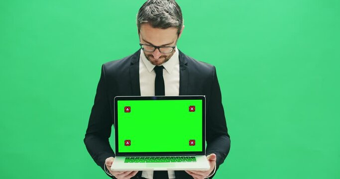Dont delay and display here. 4k video footage of a businessman holding a laptop with a green screen display against a green background.