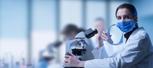 Researcher using a microscope in the lab