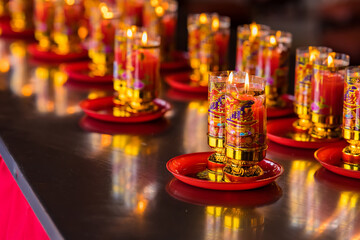 Bangkok, Thailand - January, 26, 2022 : Praying and meditation with burning candle on Chinese temple in Wat Leng Nei Yee 2 Temple at Bangkok, Thailand.