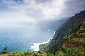 Fototapeta na wymiar City in the marina. Madeira scenic mountain and ocean view.