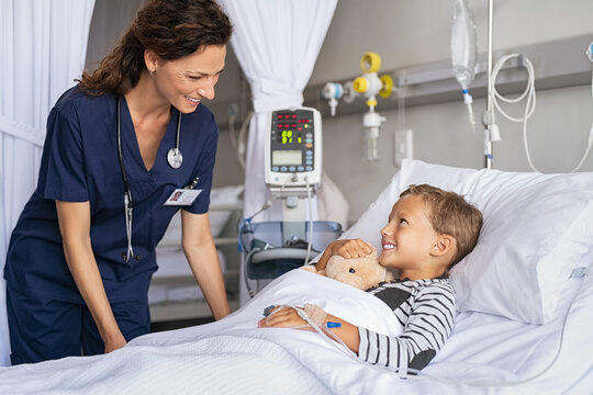 Nurse caring cute little boy patient at hospital