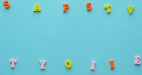 The phrase Stay Positive is made up of colorful wooden letters. 4K looped stop motion animation