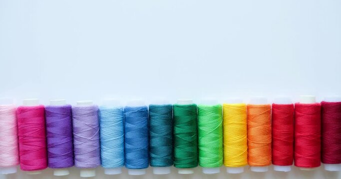 Multicolored spools of thread and space for text. 4K looped stop motion animation