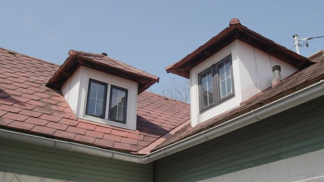 dormers on red shingled roof of house