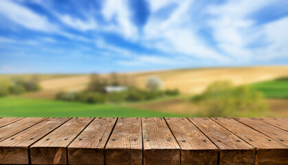 Empty wooden table with summer countryside in background