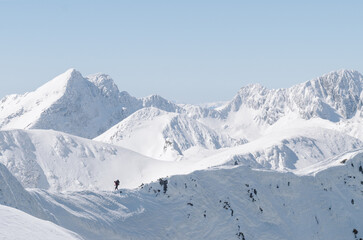 Fototapeta na wymiar Man Hiking in winter in beautiful mountain landscape 