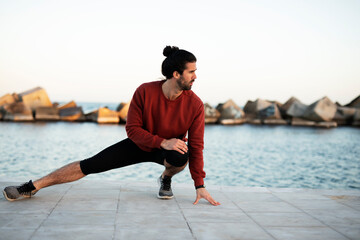 Fitness training outdoors. Handsome man working exercises in early morning. Muscular man training outside.