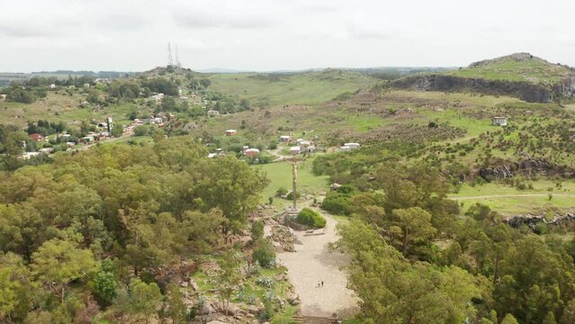 Flying above a Christian cross in a district of Tandil in Buenos Aires. A beautiful natural view opens up in front of the spectator's eyes