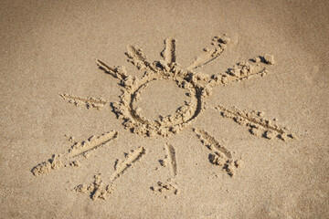 Shape of sun on sand at beach. Summer and vacation time