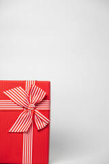 Red and striped boxes with gifts tied bows on white background