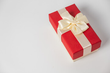 Red and striped boxes with gifts tied bows on white background