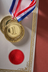 blank certificate and gold medal with ribbon