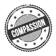 COMPASSION text written on black grungy round stamp.