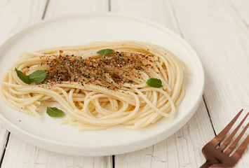 spaghetti on a white plate with basil, Italian cuisine