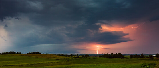 Thunder storm clouds with lightning strikes across the fields, summer, Lithuania