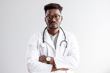 Portrait of smiling black male doctor with stethoscope on white background. Young happy black medical doctor holding medical chart over white studio background, copy space..