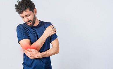 Person with elbow pain, concept of a man with rheumatism elbow pain, man massaging sore elbow, man with elbow cramp