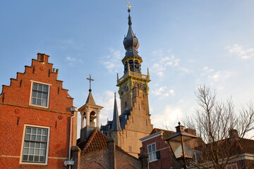 Traditional medieval houses and the Stadhuis (town hall) with its impressive clock tower in Veere, Zeeland, Netherlands