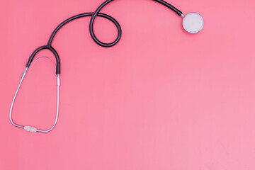 Fototapeta premium stethoscope on pink background and copy space