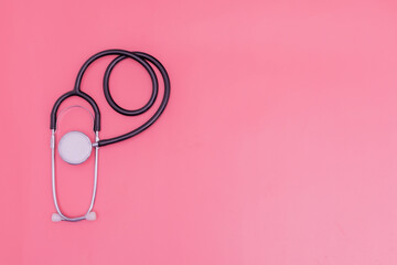 stethoscope on pink background and copy space
