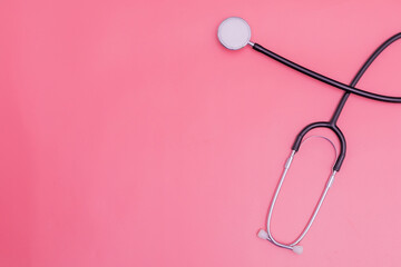 stethoscope on pink background and copy space