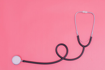 Fototapeta premium stethoscope on pink background and copy space