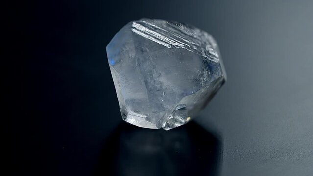 A precious rough stone for jewelry production rotates on an exhibition display