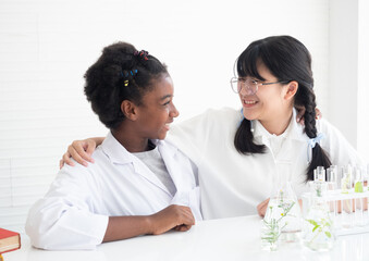 Fototapeta premium Group of happy kids doing science experiments in the laboratory. Team of girl student scientist in the classroom. Educational, Early development of children.
